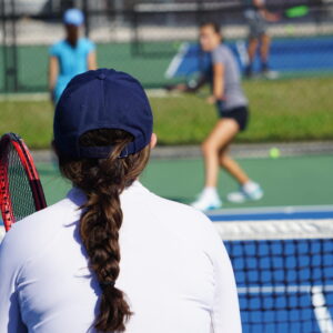 NMBA junior female tennis coach with braid North Miami Beach Academy training