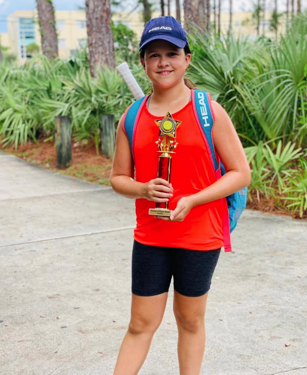 Allysa Stungis with tournament trophy — NMBA junior tennis champion