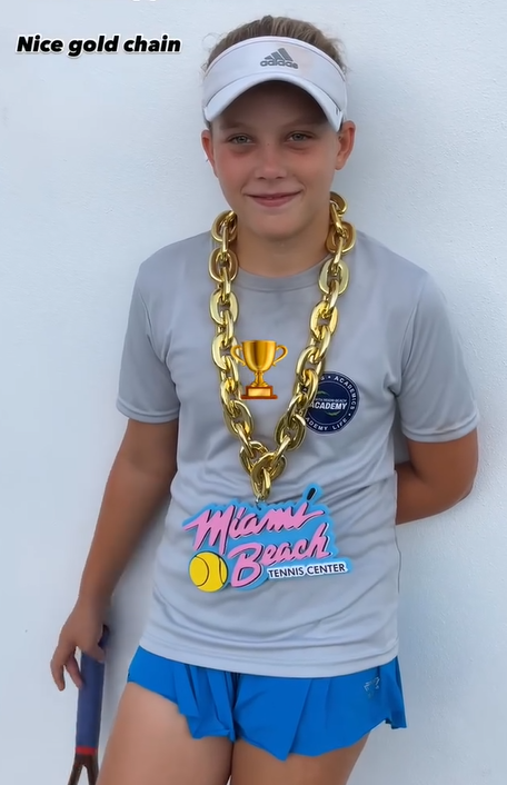 Frankie A. with championship trophy — NMBA junior tennis tournament winner